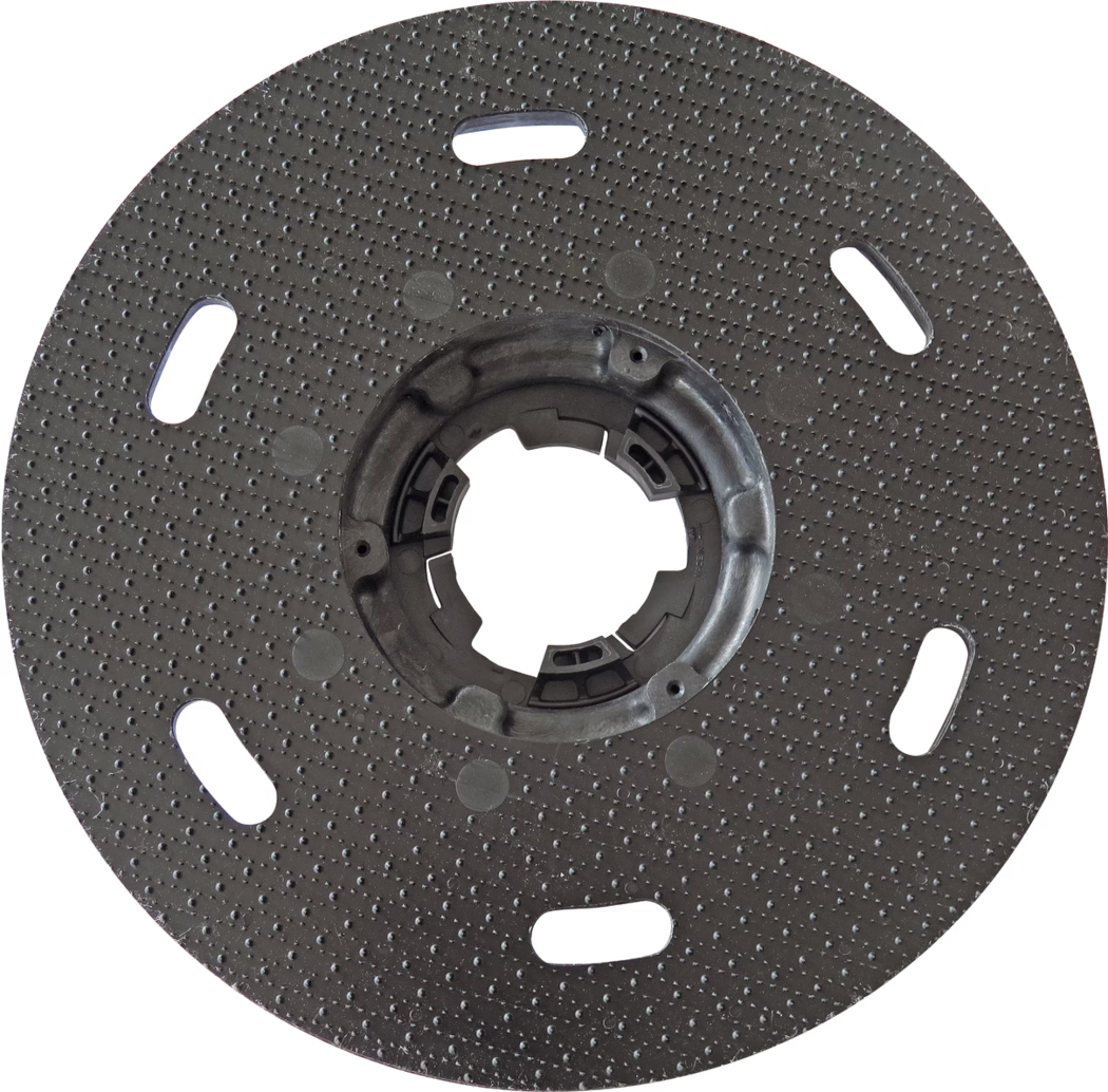 Circular black plastic backing plate with a textured dotted surface and a central locking hub; several elongated oval slots are evenly spaced near the outer area; a central round opening contains molded retention features for attaching to a tool; intended as a mounting pad for sanding or polishing discs; the surface has uniformly raised dots to improve grip; slight signs of use are visible; photographed on a white background.